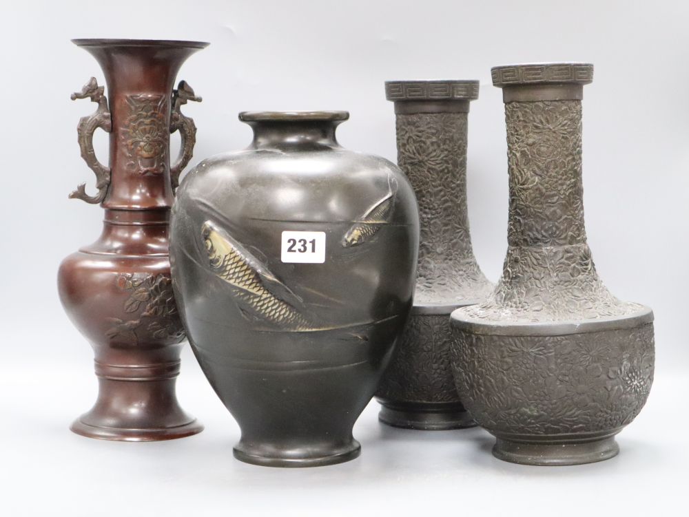 A pair of Japanese bronze vases, a dragon handled bronze vase and a fish decorated bronze vase, tallest 33cm